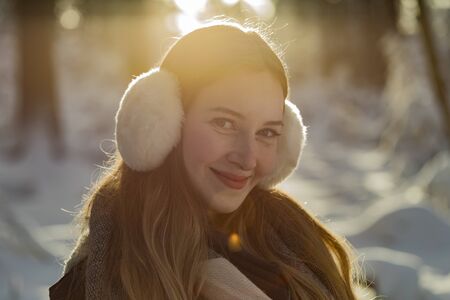 young woman snow walk beauty portrait fun smile candidの写真素材