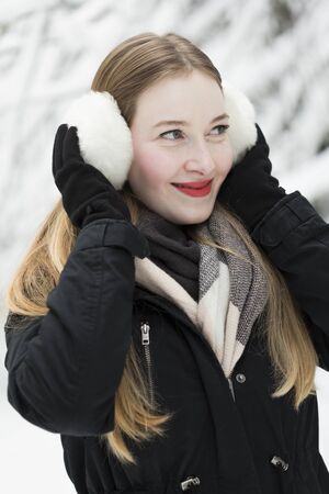 young woman snow walk beauty portrait fun smile candidの写真素材