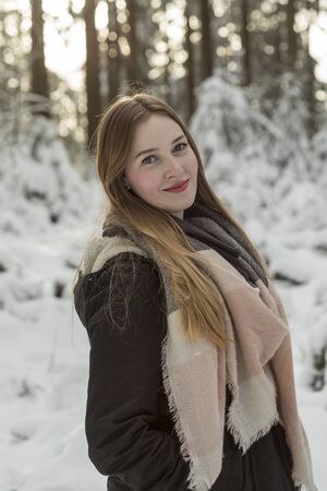 young woman snow walk beauty portrait fun smile candidの写真素材