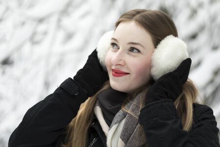 young woman snow walk beauty portrait fun smile candidの写真素材