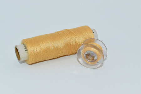 Sewing thread,tape and needle on the table