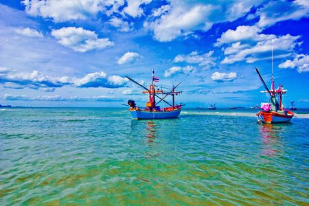 the fishing doat, a sea green water, the sky is blue,の写真素材