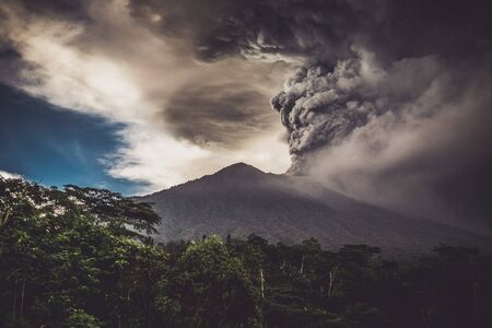 Series of photos from the eruption volcano Agung in Bali with beautiful views of the nature. Big smoke and ash cover the skyの写真素材