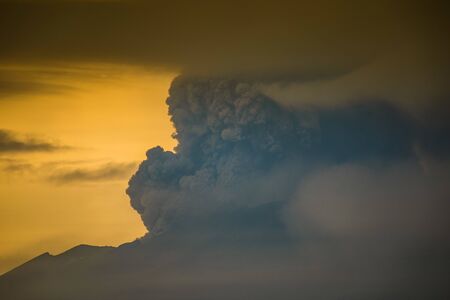 Series of photos from the eruption volcano Agung in Bali. Big smoke and ash cover the skyの写真素材