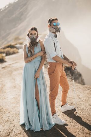Man and woman standing in front of a mountainの写真素材
