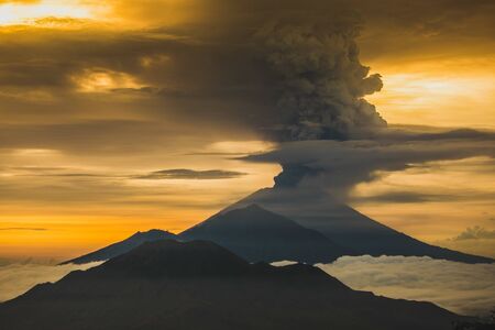 Series of photos from the eruption volcano Agung in Bali with beautiful views of the nature and volcano Batur. Big smoke and ash cover the sky の写真素材
