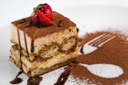 A piece of tiramisu on a plateの写真素材