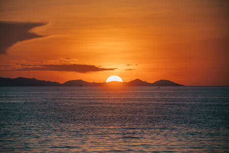 the sunsets in an even circle over the horizon. big sun. seascape. flores.の写真素材