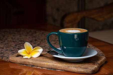 Coffee cup on stone kitchen table. Cappuccino, hot latte or coffee with milk.の写真素材