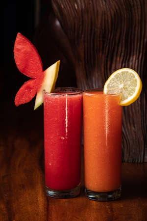 Watermelon and papaya smoothie on wood background. Healthy juice. Detox healthyの写真素材