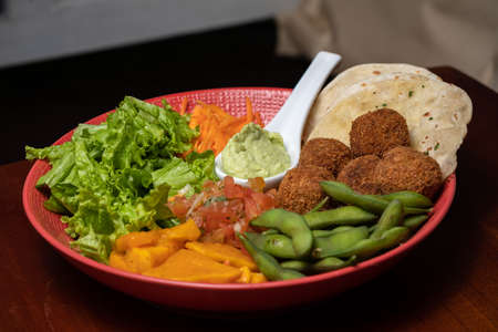 Vegan falafel with vegetables and tzatziki sauce. Arabic food, Buddha bowl pitaの写真素材