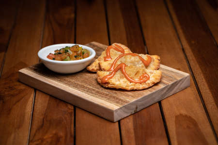 Traditional spanish tapas with tomatoes and avocado sauces. Fried empanadas.の写真素材