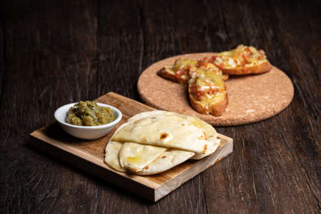 Bruschetta with half dried tomatoes and cheese. Pita, humus. tacos and snack.の写真素材