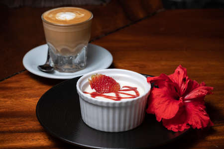 Traditional italian dessert vanilla panna cotta with fresh strawberries, coffeeの写真素材