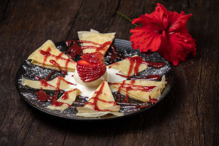 Crepe or fine pancake with pieces strawberry and vanilla ice cream. Whip creamの写真素材
