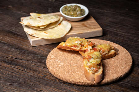 Bruschetta with half dried tomatoes and cheese. Pita, humus. tacos and snack.の写真素材