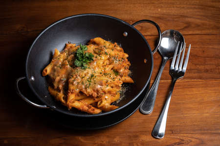 Pasta penne with spicy tomato sauce, parmesan and parsley.の写真素材