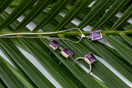Silver jewelry with purple stone set with pendant, chain, earrings, ringの写真素材