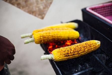 grilled sweet corn near the beach during sunset time,barbecue concept, in Bali, Indonesiaの写真素材