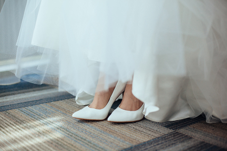 Detail of bridal legs with shoes. Wedding dress detailの写真素材