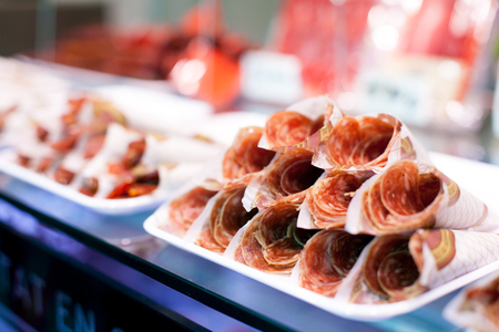 Parma ham or Hamon on display for sale at the Boqueria market in Barcelonaの写真素材