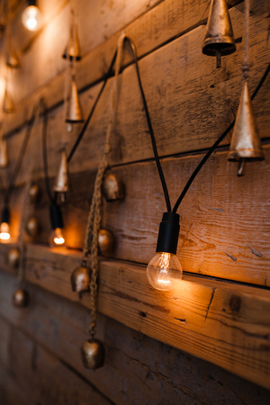 Hanging light bulb over the wooden background. Background wood planks with lampsの写真素材
