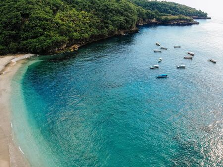 beautiful turquoise ocean water with many boats on it top view aerial photo with white beach and...
