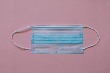 Doctor medical mask and coronavirus protection isolated on a pink background.の写真素材