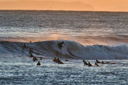 Surfing big waves in Santa Barbara Harborの写真素材
