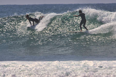 surfing summer waves in Malibuの写真素材