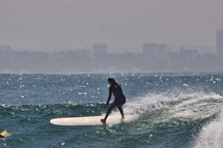 Surfing summer waves in Malibuの写真素材
