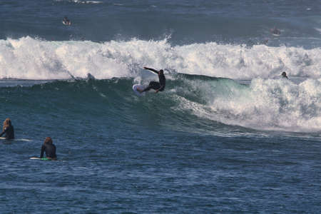 Surfing summer waves at Malibu beach
