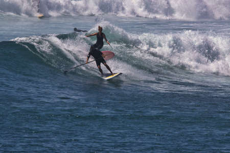 Surfing summer waves in Malibu Californiaの写真素材