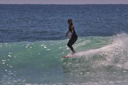 Surfing summer waves a Malibu beach