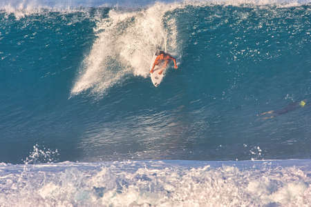 Surfing giant waves at Pipeline in Hawaii