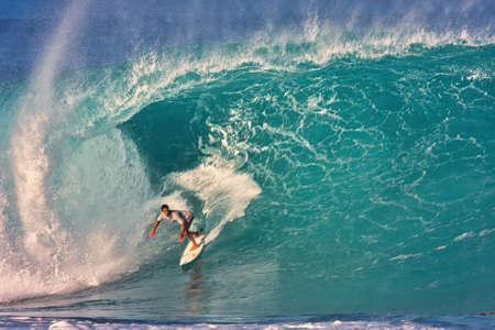 Surfing giant waves at Pipeline in Hawaii