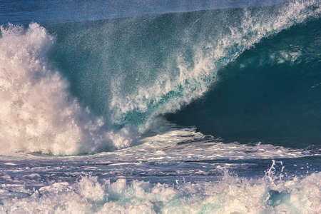 Surfing giant waves at Pipeline on the north shore Oahu Hawaiiの写真素材