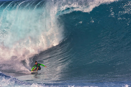 Surfing giant waves at Pipeline on the north shore Oahu Hawaii