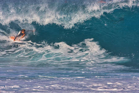 Surfing giant waves at Pipeline on the north shore Oahu Hawaii
