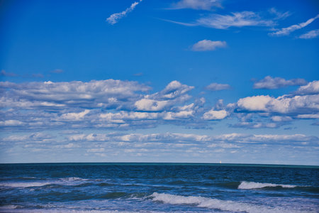 Blue sky with white clouds over the sea. Beautiful seascape.の写真素材