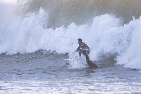 Surfer in action on the beach. Surfer on the wave.