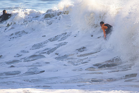 Surfer in action at the beach on a sunny winter day.の写真素材