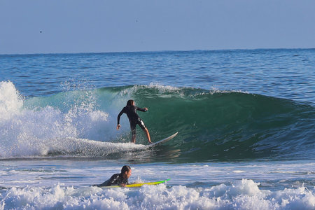 Surfer in action on the ocean wave on a sunny day.の写真素材