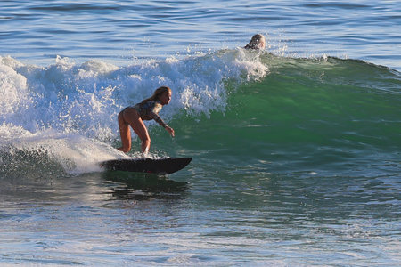 Surfer in action at the beach on a beautiful sunny day.