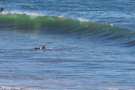 Surfers on the beach of La Jolla, California.