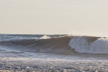 Surfers on the beach of Punta Arenas, Chile