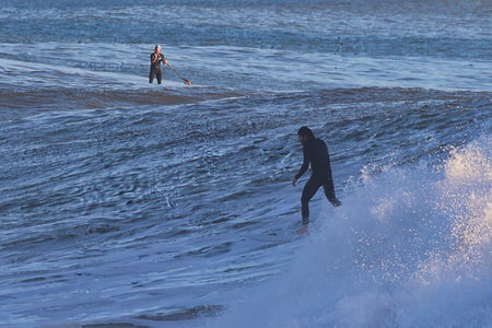 Surfer in action at the beach on a beautiful sunny day.