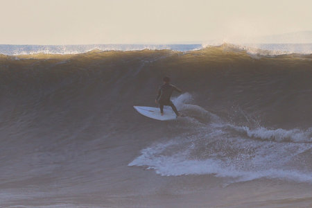 Surfer on the Amazing Wave at Sunset, Bali, Indonesiaの写真素材