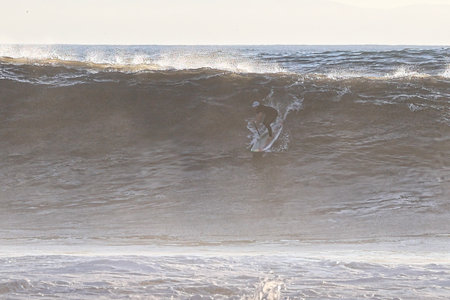 Surfer in the ocean on a stormy day. Toned.