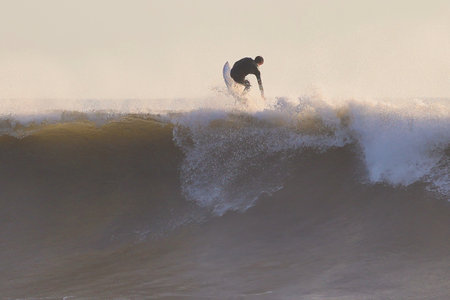Surfer in action on the ocean wave on a sunny day.の写真素材